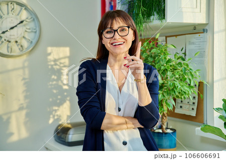 Middle aged positive female looking at camera in home 106606691