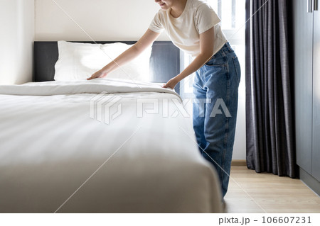 Asian young woman making bed arranging blanket,bedding in her bedroom after wake up,happy smiling teen girl cleaning the room,enjoy while doing housekeeping at home,housework,health hygiene concept Asian young woman making bed arranging blanket,bedding in her bedroom after wake up,happy smiling teen girl cleaning the room,enjoy while doing housekeeping at home,housework,health hygiene concept 106607231