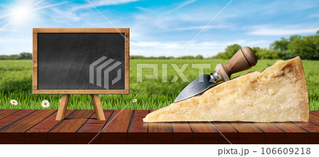 Slice of Italian Parmesan Cheese with Knife and Empty Blackboard Slice of Italian Parmesan Cheese with Knife and Empty Blackboard 106609218