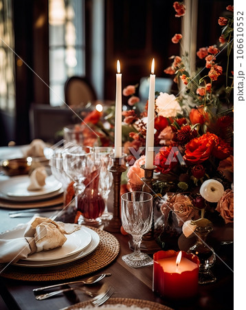 Beautiful fall table setting, autumn dinner table decoration with flowers and candles, holiday event decor in orange and yellow colors 106610552