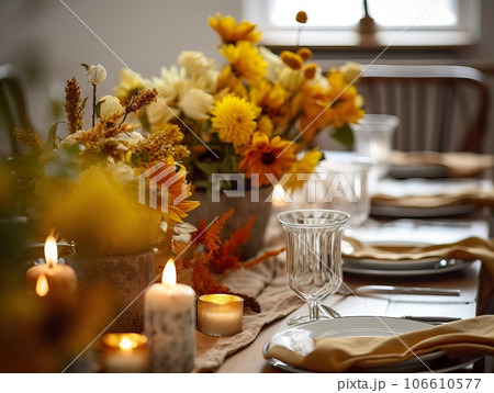 Beautiful fall table setting, autumn dinner table decoration with flowers and candles, holiday event decor in orange and yellow colors 106610577