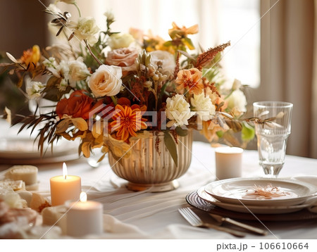Beautiful fall table setting, autumn dinner table decoration with flowers and candles, holiday event decor in orange and yellow colors Beautiful fall table setting, autumn dinner table decoration with flowers and candles, holiday event decor in orange and yellow colors 106610664