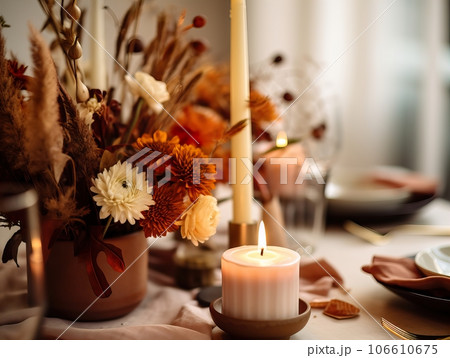 Beautiful fall table setting, autumn dinner table decoration with flowers and candles, holiday event decor in orange and yellow colors Beautiful fall table setting, autumn dinner table decoration with flowers and candles, holiday event decor in orange and yellow colors 106610675