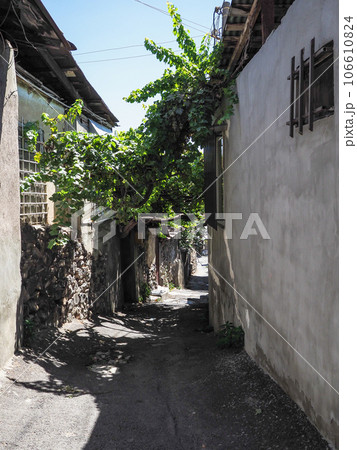old narrow stone street between houses in Yerevan 106610824