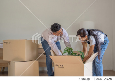 Couple Indian happy carrying box on moving day in of home new Couple Indian happy carrying box on moving day in of home new 106612320