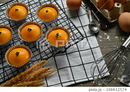 Traditional dessert for Chinese Mid-Autumn festival. Chinese pastry with stuffed salted yolk on wooden kitchen table Traditional dessert for Chinese Mid-Autumn festival. Chinese pastry with stuffed salted yolk on wooden kitchen table 106612574