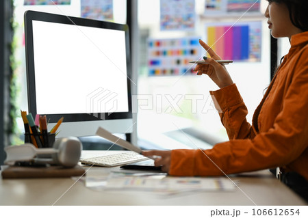 Creative woman using digital tablet and working with choosing color samples on desk at graphic studio Creative woman using digital tablet and working with choosing color samples on desk at graphic studio 106612654