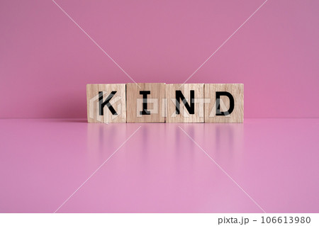 Wooden blocks form the text "KIND" against a pink background. 106613980