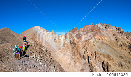 Group of hikers climbing stony mountains 106615086
