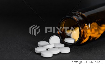 Vial with pills on black background with copy space. 106615648