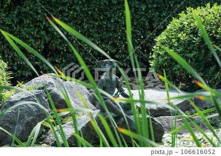 kappa sculpture on the bank of a pond in the Japanese Garden of the St. Petersburg Botanical Garden 106616052