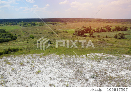 Ancient multimillion chalk mountains on the steppe surface of earth 106617597