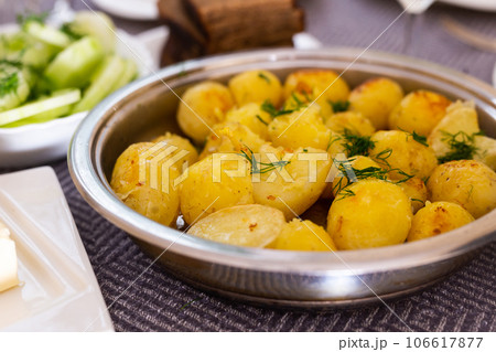 Toasted young potatoes with dill in metal skillet Toasted young potatoes with dill in metal skillet 106617877