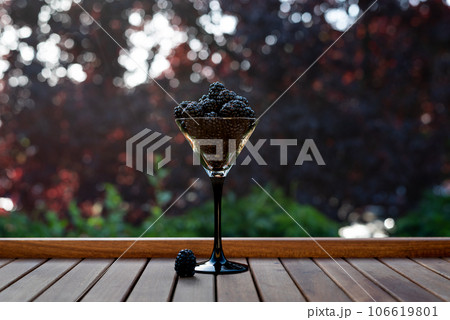 Fresh sweet blackberry in glass on a wooden table, rustic background, selective focus Fresh sweet blackberry in glass on a wooden table, rustic background, selective focus 106619801