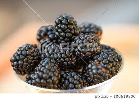 Fresh sweet blackberry in glass on a wooden table, rustic background, selective focus Fresh sweet blackberry in glass on a wooden table, rustic background, selective focus 106619806