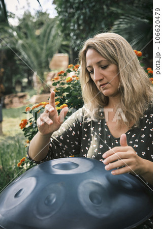 a woman plays on handpan or hang 106620479