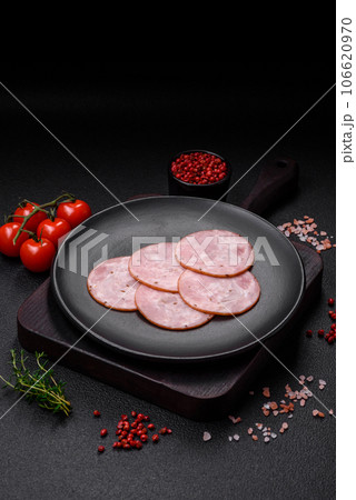 Delicious fresh ham cut into round slices with salt, spices and herbs Delicious fresh ham cut into round slices with salt, spices and herbs 106620970
