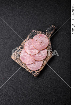 Delicious fresh ham cut into round slices with salt, spices and herbs Delicious fresh ham cut into round slices with salt, spices and herbs 106620982