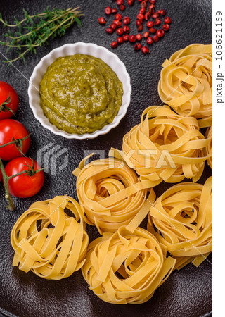 Delicious fresh pasta consisting pesto sauce with salt, spices and herbs Delicious fresh pasta consisting pesto sauce with salt, spices and herbs 106621159