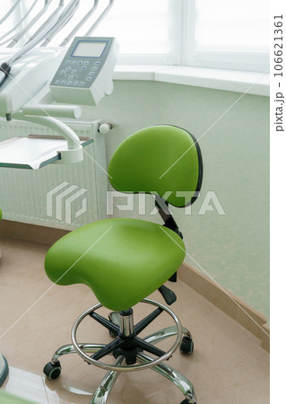 Modern dental office. Dentist's tools for dental treatment. The workplace of the dentist in the clinic. Dentist's green chair Modern dental office. Dentist's tools for dental treatment. The workplace of the dentist in the clinic. Dentist's green chair 106621361