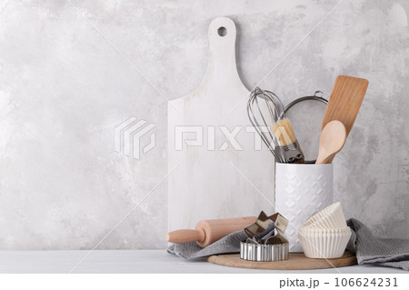 Kitchen shelf with white modern ceramic and wooden dishware 106624231