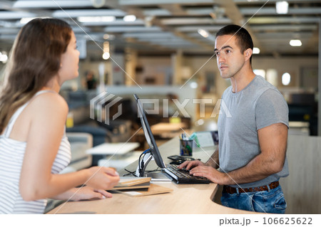 Male consultant helps a female customer choose materials for making furniture 106625622
