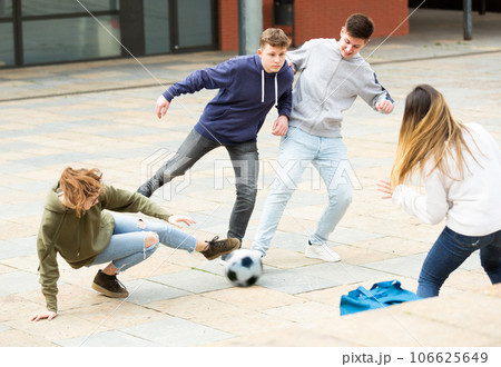Cheerful schoolchildren are playing football 106625649