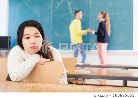 Portrait of unhappy female chinese student in auditorium Portrait of unhappy female chinese student in auditorium 106625653