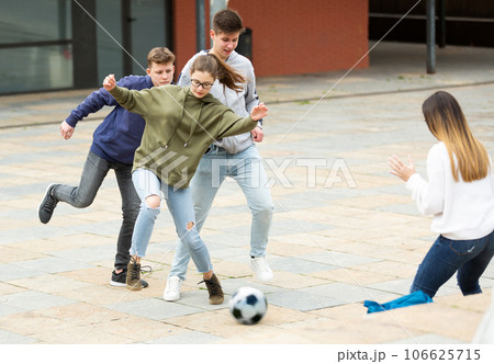 Cheerful schoolchildren are playing football 106625715