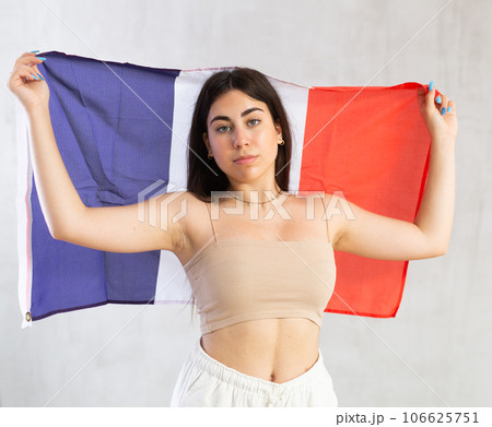 Young woman with flag of France posing in studio 106625751