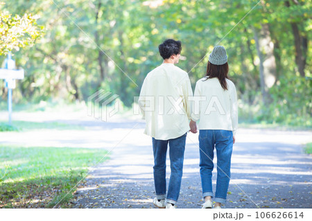手を繋いで歩くカップル 106626614