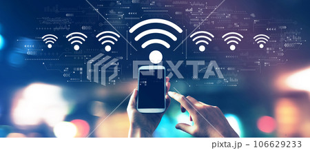 Wifi theme with a smartphone in city lights at night 106629233