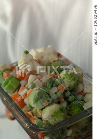 Unrecognizable woman showing Frozen mixed vegetables homemade. Harvesting concept. Stocking up vegetables for winter storage Unrecognizable woman showing Frozen mixed vegetables homemade. Harvesting concept. Stocking up vegetables for winter storage 106629496