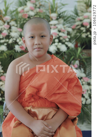 portrait of buddhist novice wearing thai monk clothes standing outdoor 106629772