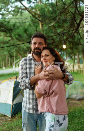 Young married couple emracing and standing in the forest in the evening 106631225