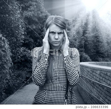 Girl with a headache on the street 106633396