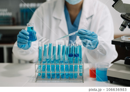 Female scientist researcher conducting an experiment working in the chemical laboratory. Female scientist researcher conducting an experiment working in the chemical laboratory. 106636983