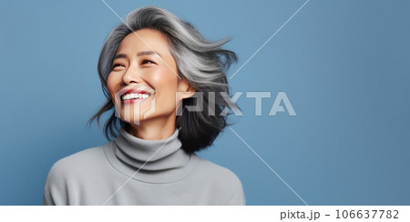 Middle-aged Asian woman with a short gray hairdo looking at copy space. 106637782