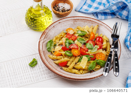 Italian pasta adorned with fresh tomatoes and aromatic basil 106640571