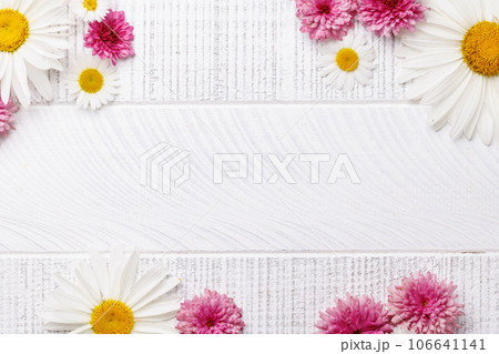 Garden blossom flower heads on wooden background 106641141