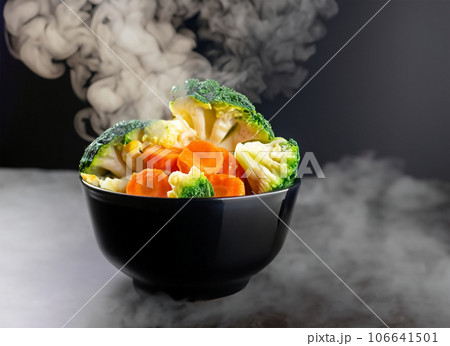 The steam from the vegetables carrot broccoli Cauliflower in a black bowl a steaming Boile. Generative AI. 106641501