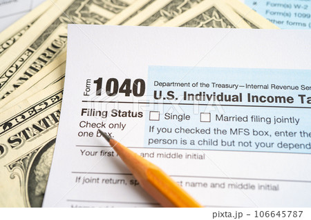 Tax Return form 1040 with USA America flag and dollar banknote, U.S. Individual Income. Tax Return form 1040 with USA America flag and dollar banknote, U.S. Individual Income. 106645787