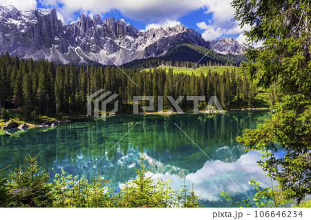 Idyllic nature scenery- turquoise mountain lake Carezza surrounded by Dolomites rocks- one of the most beautiful lakes of Alps. South Tyrol region. Italy Idyllic nature scenery- turquoise mountain lake Carezza surrounded by Dolomites rocks- one of the most beautiful lakes of Alps. South Tyrol region. Italy 106646234