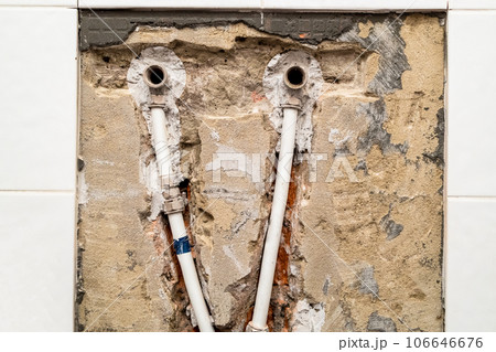 old plumbing with metal-plastic pipes in wall old plumbing with metal-plastic pipes in wall 106646676