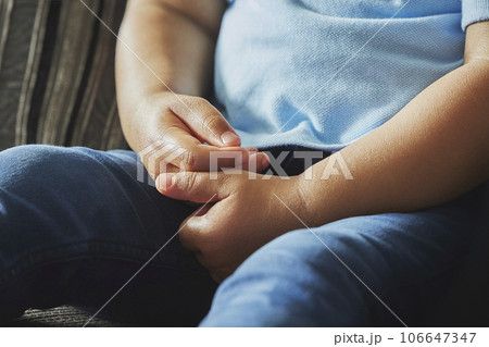 Black baby on the sofa. Hands close up Black baby on the sofa. Hands close up 106647347