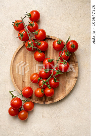 Fresh cherry tomatoes in wooden bowl. 106647526