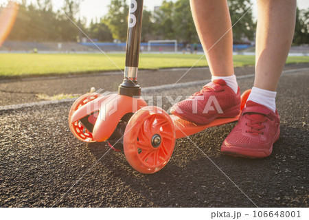 Little boy is riding scooter. Seasonal child activity sport Little boy is riding scooter. Seasonal child activity sport 106648001