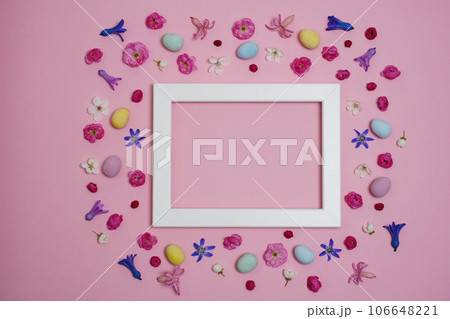 Creative Easter composition. Easter eggs, spring flowers, photo frame on pink background. Flat lay, top view, copy space, mock up. Creative Easter composition. Easter eggs, spring flowers, photo frame on pink background. Flat lay, top view, copy space, mock up. 106648221