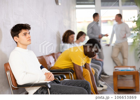 Portrait of a young man sitting waiting 106653869