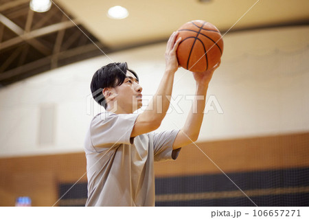 体育館のコートで一人トレーニングをする男子大学生 体育館のコートで一人トレーニングをする男子大学生 106657271